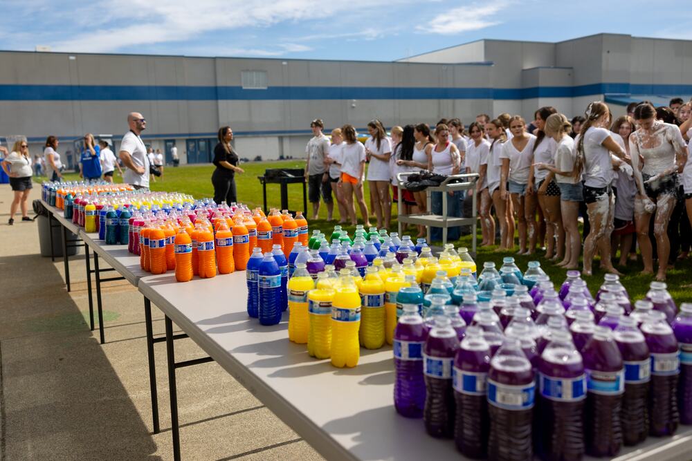 Rows of squeeze bottles filled with colored water lined up along the tables, waiting for the color fight.