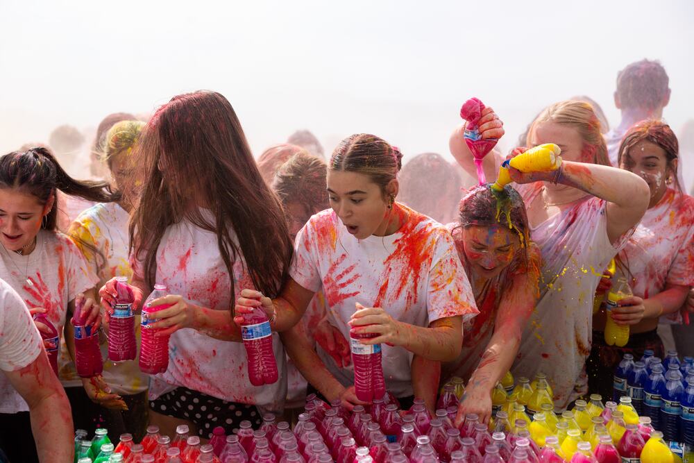 Seniors crowded around the bottle tables, reloading in the middle of the color fight.