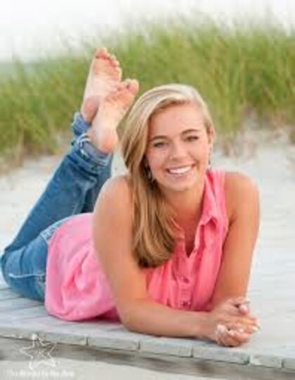 A senior lying full length on a beach boardwalk